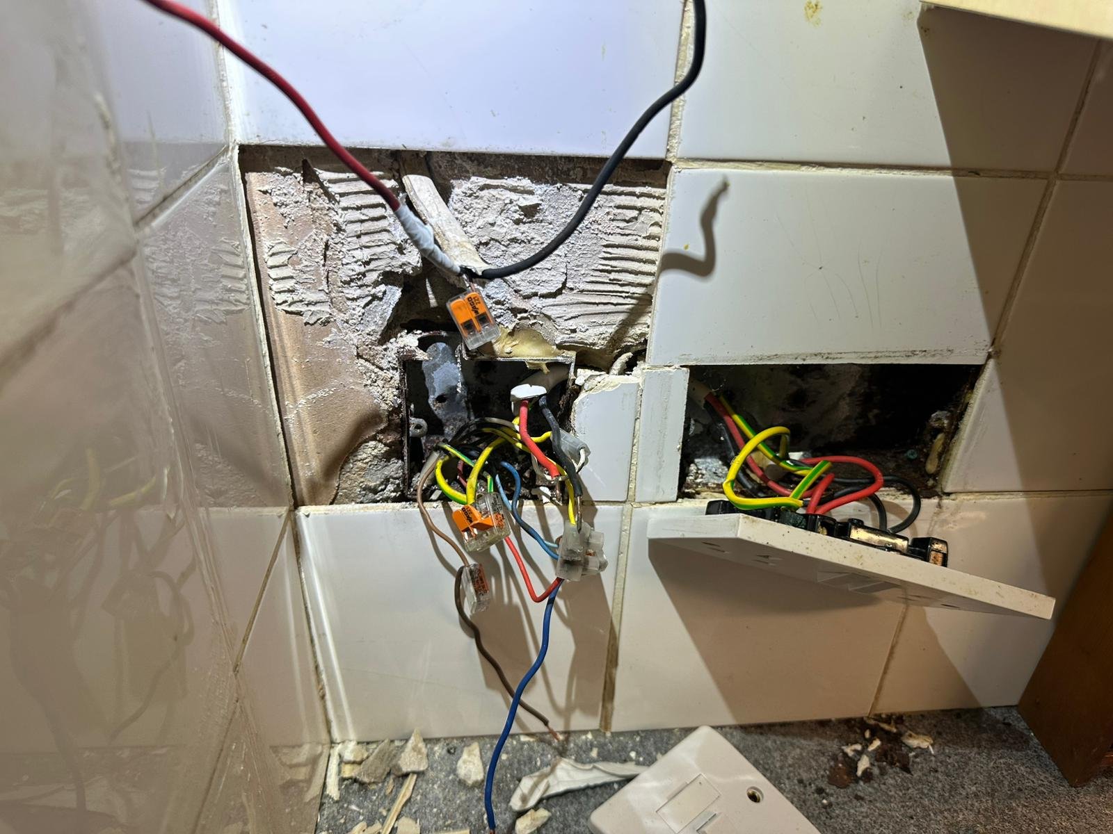 Damaged socket boxes and exposed connections of the kind recorded as observations on a report