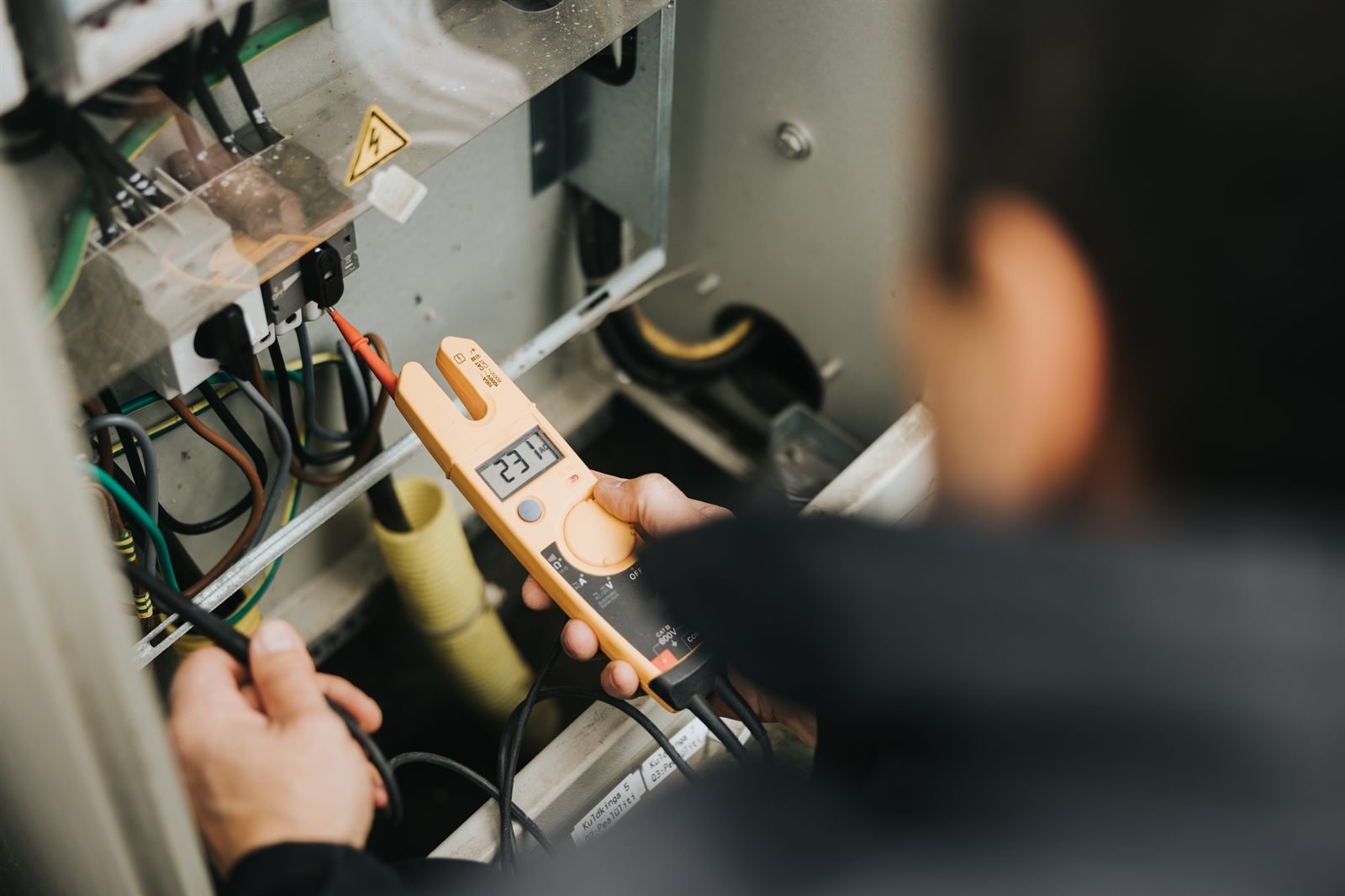 Electrician walking a customer through socket wiring in a kitchen