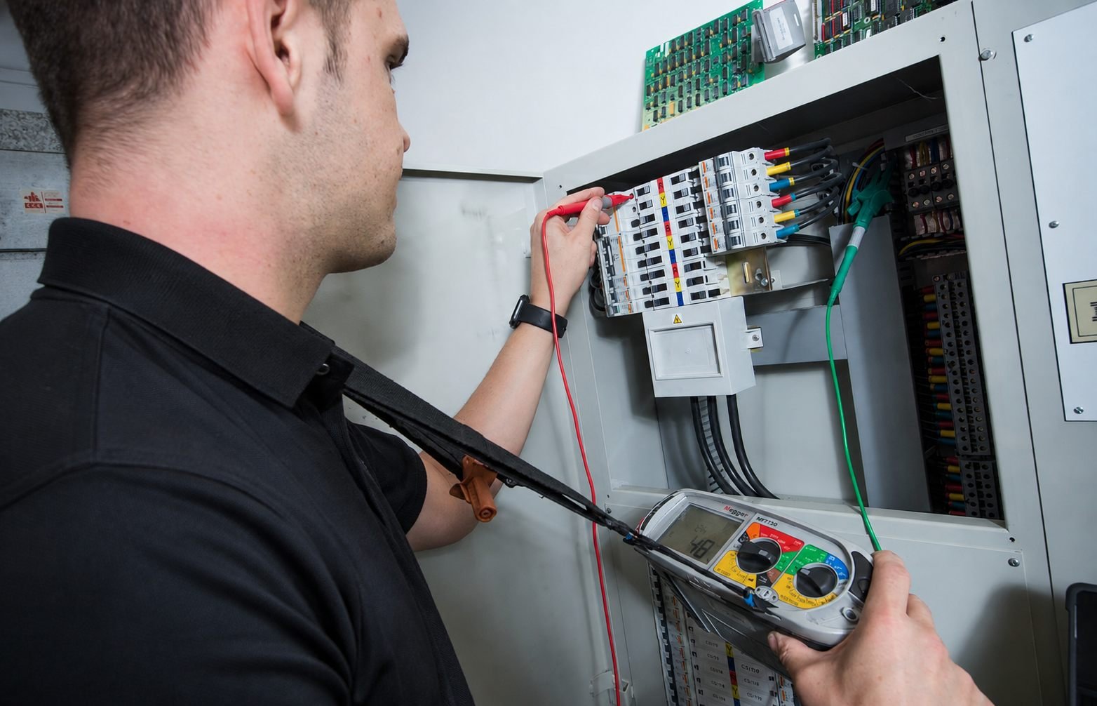 Multifunction tester running an EICR test sequence in front of a consumer unit